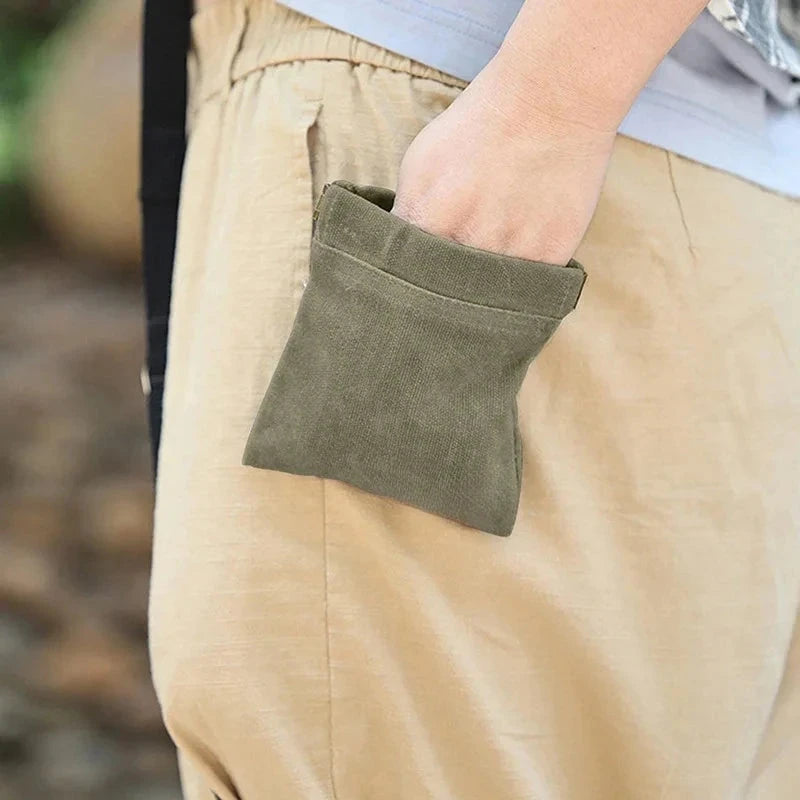Close-up of beige pants with a green pocket on a blurred background
