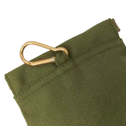 Green fabric with a gold metal clip on a white background