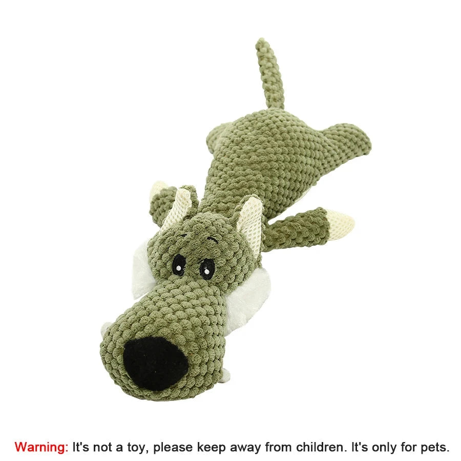 Green crocheted dragon toy on a white background with a warning label.