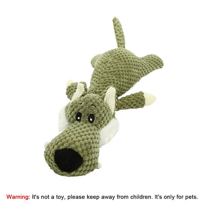 Green crocheted dragon toy on a white background with a warning label.
